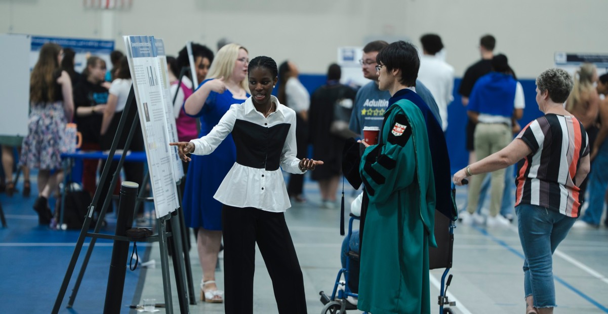 Student presenting poster at Celebration of Excellence