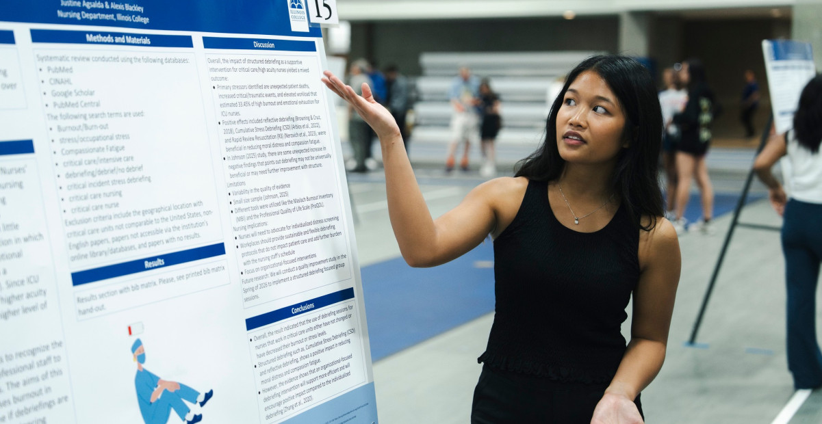 Student presenting poster at Celebration of Excellence