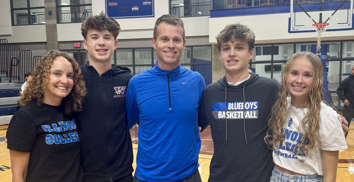 The Schoufler family posing on the basketball court