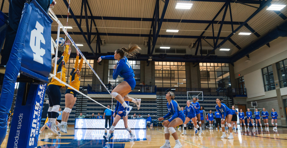 Lady Blues volleyball player spiking the ball 