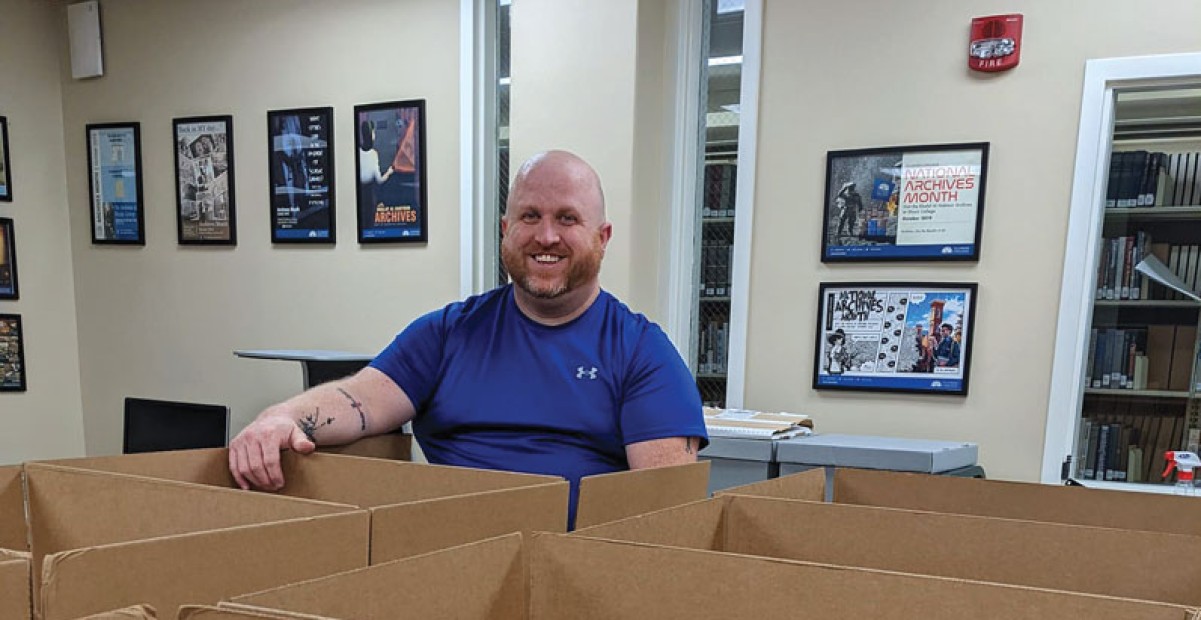 Ryan Roberts, director of Schewe Library packs up copies of The Rambler