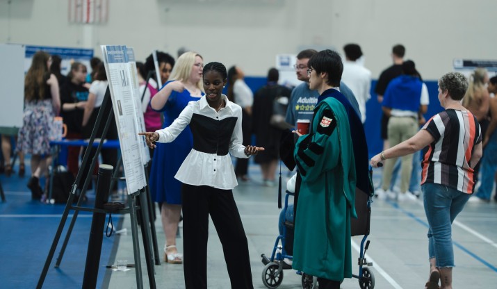 Student presenting poster at Celebration of Excellence