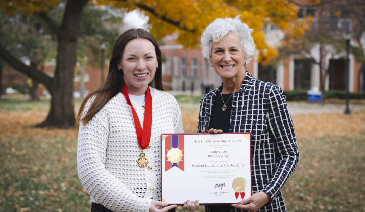 Emily Guest ’26 and President Barbara A. Farley holding Lincoln Laureate certificate