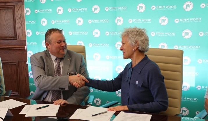 Dr. Bryan Renfro, JWCC (JWCC) President and Dr. Barbara Farley, Illinois College (Illinois College) President, shake hands after signing agreements.